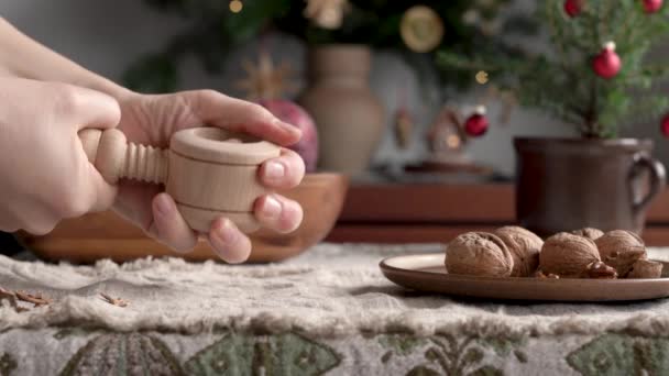 Hands Cracking Walnuts Nutcracker Decorated Christmas Tree Background — Stock video