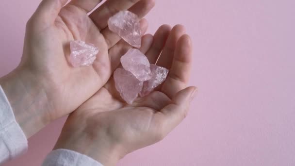 Pouring Pink Rose Quartz Crystals One Hand Other Slow Motion — Vídeo de stock