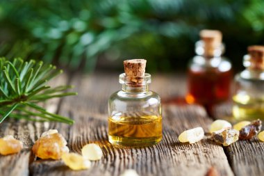 Christmas still life with aromatherapy essential oils, frankincense resin and fir tree branches
