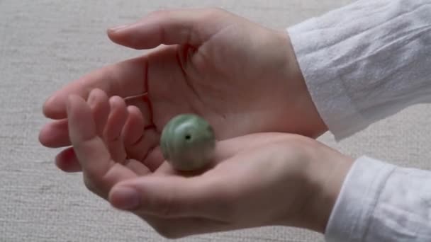 Woman Hands Showing Green Jade Egg Slow Motion — Stock Video