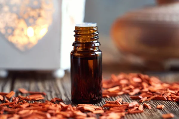 Een Donkere Fles Aromatherapie Etherische Olie Met Rode Sandelhoutchips Een — Stockfoto