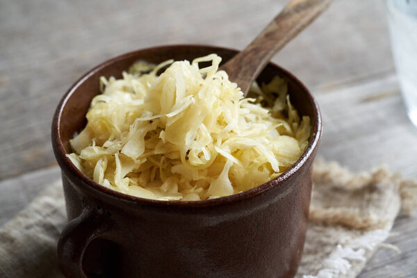 Fermented cabbage in a brown pot, close up