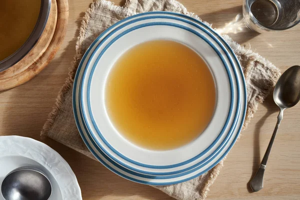 Een Bord Van Runderbeen Aftreksel Een Witte Bord Een Tafel — Stockfoto