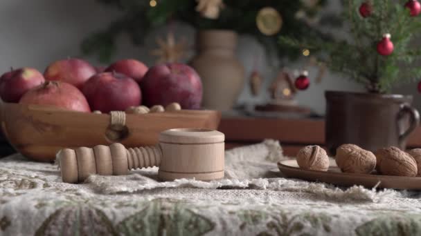 Hands Putting Walnut Nutcracker Decorated Christmas Tree Apples Background — Stock Video