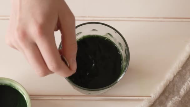 Hand Stirring Chlorella Algae Powder Glass Water Top View — Stock Video