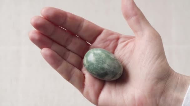 Female Hand Holding Green Jade Egg — Stock Video