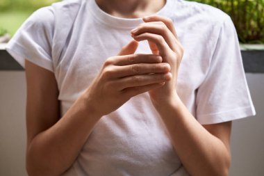 Hands of a childl practicing EFT or emotional freedom technique - tapping on the karate chop point
