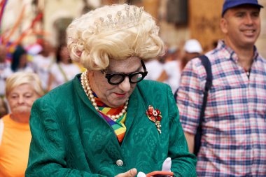 PRAGUE, CZECH REPUBLIC - AUGUST 13, 2022: Man disguised as queen in the street during gay pride