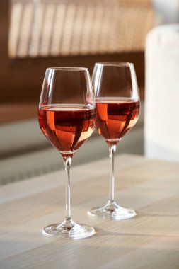 Two glasses of still rose wine on a table indoors