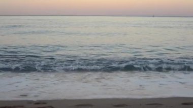 Blue sea with waves on an empty beach in Turkey in the summer at dawn