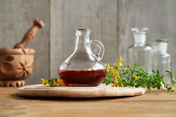 A bottle of herbal oil made from St. John\'s wort flowers. Alternative medicine.