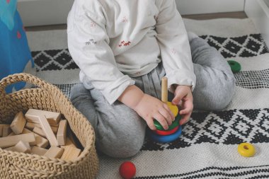 Küçük erkek bebek ve evdeki gelişim oyuncakları. Çocuk gelişimi için Montessori. Yakın plan.