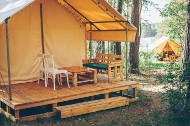 Path to glamping tent with view on woods. Camping and outdoor concept.