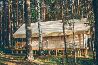Glamping tent house in forest. Camping and vacation outdoor concept. Rest at nature.