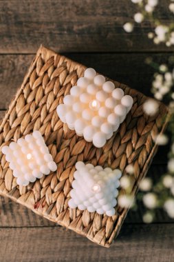 Home interior floral decor. Three bouble white homemade candles. Top view
