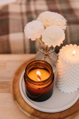Home aroma fragrance diffuser and burning candles with wooden wick. Interior elements.