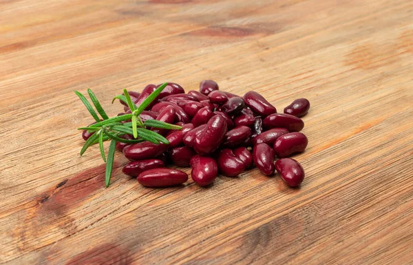 Red kidney beans on wood background. Cooked bean pile, baked legume, canned red beans, rajma, Phaseolus vulgaris, leguminous salad ingredient