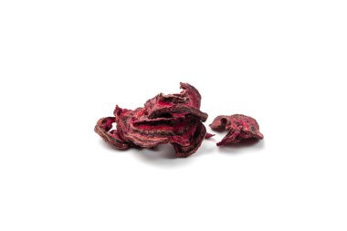 Dry beetroot flakes isolated. Dried sliced red beet pile, beet root pileces and chips, dry beetroot flake heap on white background side view