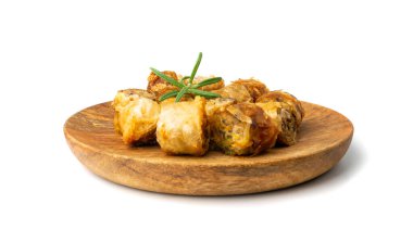 Spring rolls isolated. Rollos primavera on rustic wooden plate, fried rollito, arrollado, lumpia cuts, popiah, nem, sajgonki or fried dim sim on white background