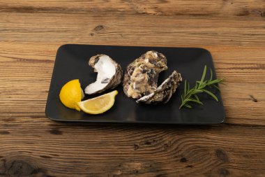 Ahşap arka planda boş istiridye kabuğu. Boş istiridye kabukları, yenmiş yumuşakçalar, kabuklu deniz hayvanları veya ahşap masadaki midyeler.