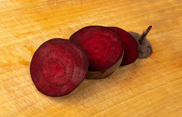 Beet root cross sections. Beetroot slices, red beets cut, pieces, portion, sliced beetroot on wood background