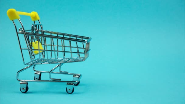 Shopping Trolley Books Moving Blue Background Stop Motion — Stockvideo