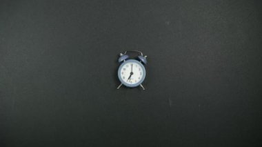 The alarm clock rings and the school supplies go into the backpack