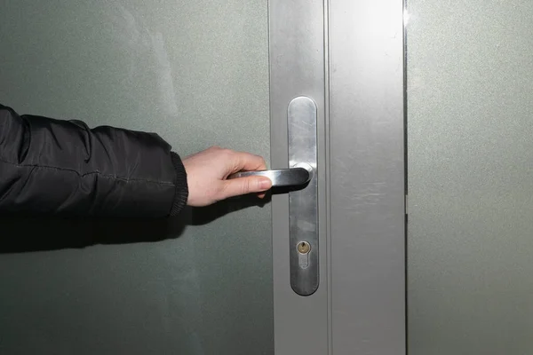 Hand hold door handle. Holding doorknob, business person opens glass door, office street enter