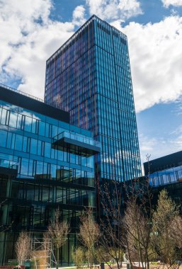 Modern office buildings, new business center facade on blue sky background, editorial image view