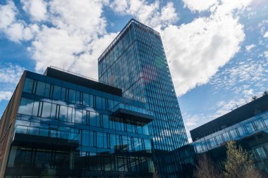 Modern office buildings, new business center facade on blue sky background, editorial image view