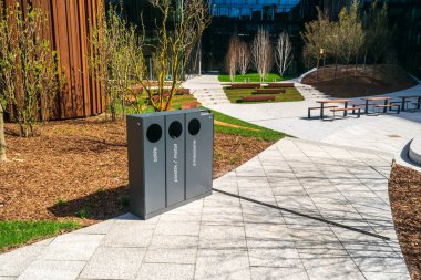 Modern garbage bins, smart metal trash can on street. New waste bin for separate trash and recyclable waste