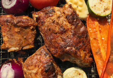 Grilled steaks and vegetables on closeup, barbecue meat, bbq food with smoke close up