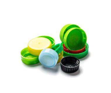 Plastik şişe kapağı izole edilmiş. Geri dönüşüm hdpe malzeme yığını, daire polietilen kapağı, beyaz arka planda renkli kapaklar