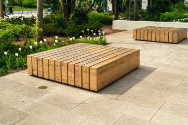 Warsaw, Poland - May 4, 2022: Old, wooden bench in park. Outdoor city architecture, wooden benches, outdoor chair, urban public furniture, empty plank seat, editorial image view