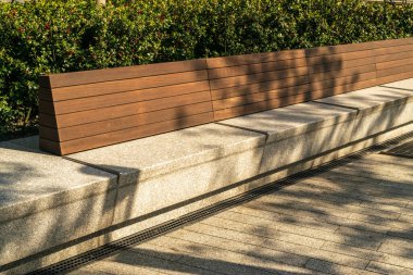 Warsaw, Poland - May 4, 2022: Old, wooden bench in park. Outdoor city architecture, wooden benches, outdoor chair, urban public furniture, empty plank seat, editorial image view