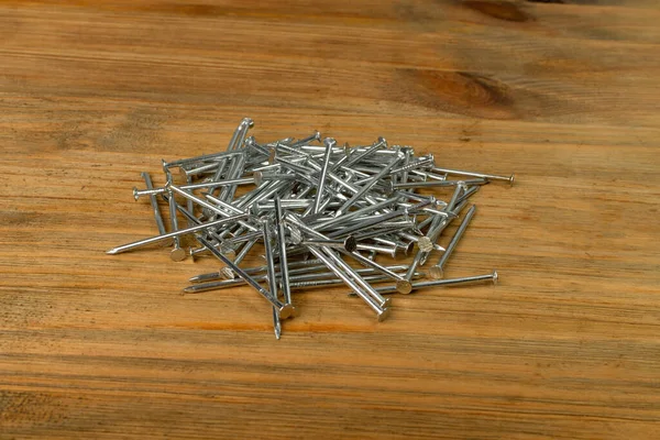 Metal Nail Pile Wooden Desk Steel Nails Wood Plate Construction — ストック写真