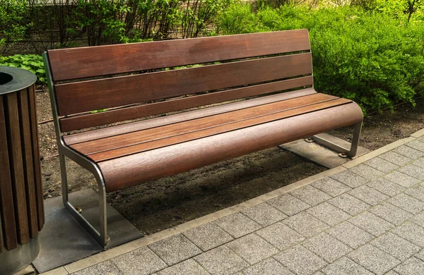 Old, wooden bench in park. Outdoor city architecture, wooden benches, outdoor chair, urban public furniture, empty plank seat, comfortable bench in recreation area