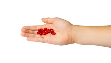 Elinde kırmızı hap kapsülleri, ağrı kesiciler, ağrı kesiciler, sakinleştiriciler, beyaz arka planda ilaç jeli kapsülleri.