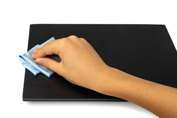 Wipe closed laptop isolated. Hand cleaning pc with blue cloth, wiping black notebook, computer care, cleaning device on white background, clipping path