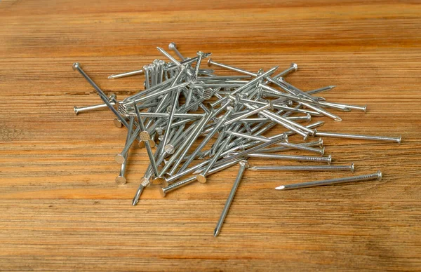 Metal Nail Pile Wooden Desk Steel Nails Wood Plate Construction — Photo