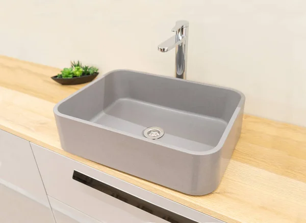 New gray sink with chromed faucet. Contemporary wash basin, modern stylish washbasin, minimal square wash bowl, neat bathroom interior, grey clean ceramic sink