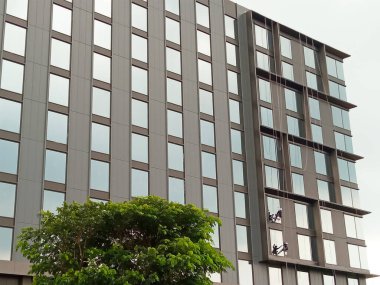 Yüksek binaların pencerelerini temizleyen işçiler