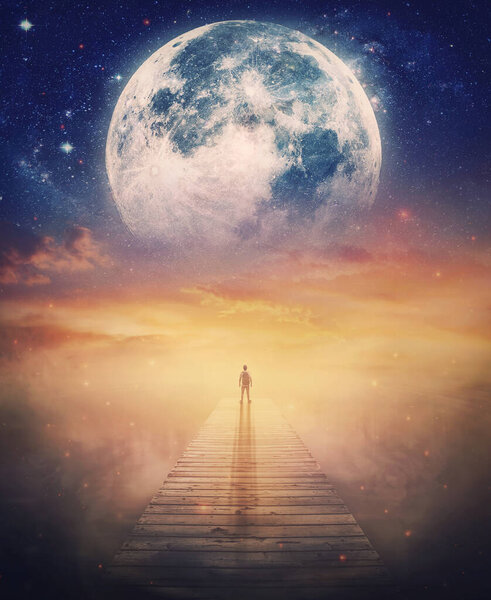 Super moon approaches the Earth, surreal scene and a lone man on the pier watching the fabulous cosmic phenomenon. Mysterious space wonder, fantastic adventure concept. Beautiful twilight scenery