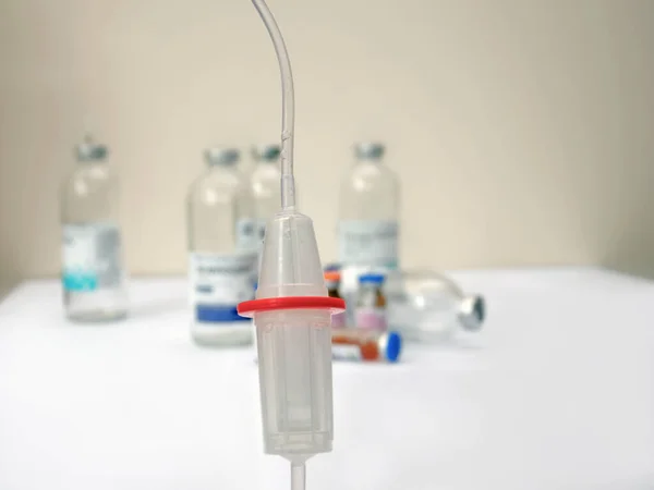 Close up of medical drip ordrip chamber in patient room. Healthcare concept,