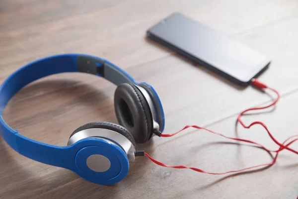 Blue Headphones Smartphone Wooden Table — Stock Photo, Image