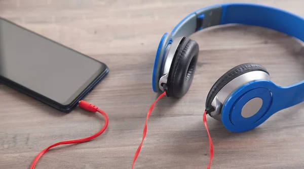 Blue Headphones Smartphone Wooden Table — Stock Photo, Image