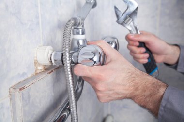 Banyodaki banyo musluğunu tamir edip tamir etmek..