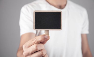 Metnin için tahta boş tahta tutan adam.