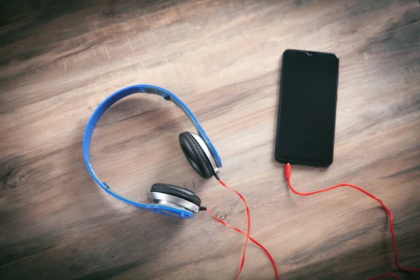 Blue Headphones Smartphone Wooden Table — Stock Photo, Image