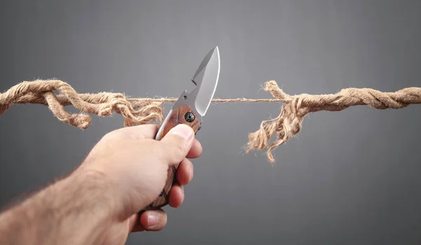 Man Knife Cutting Frayed Rope Risk — Stock Photo, Image